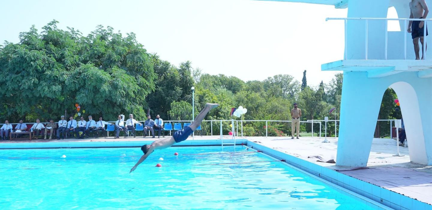 A cadet is jumping into the swimming pool
