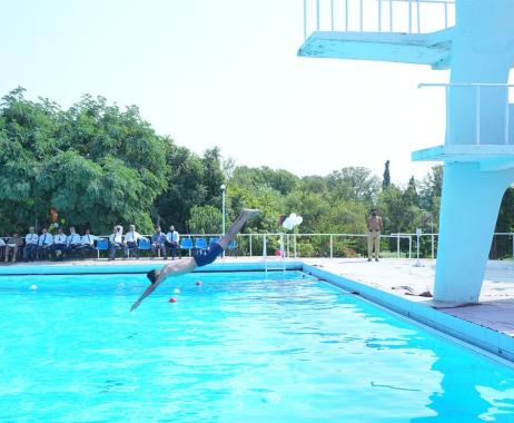 A cadet is jumping into the swimming pool